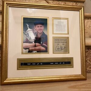 Elegant Gold Framed Golf Memorabilia with Black Accents. 
Payne Stewart
